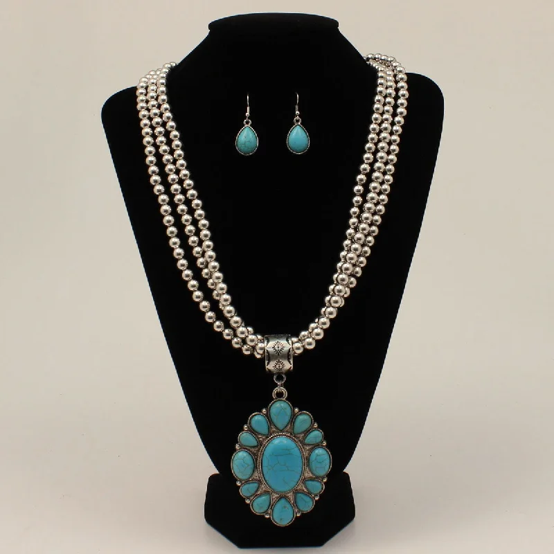 Men's western boots with a concho - studded strap and a pointed toeTriple Strand Turquoise Beaded Jewelry Set